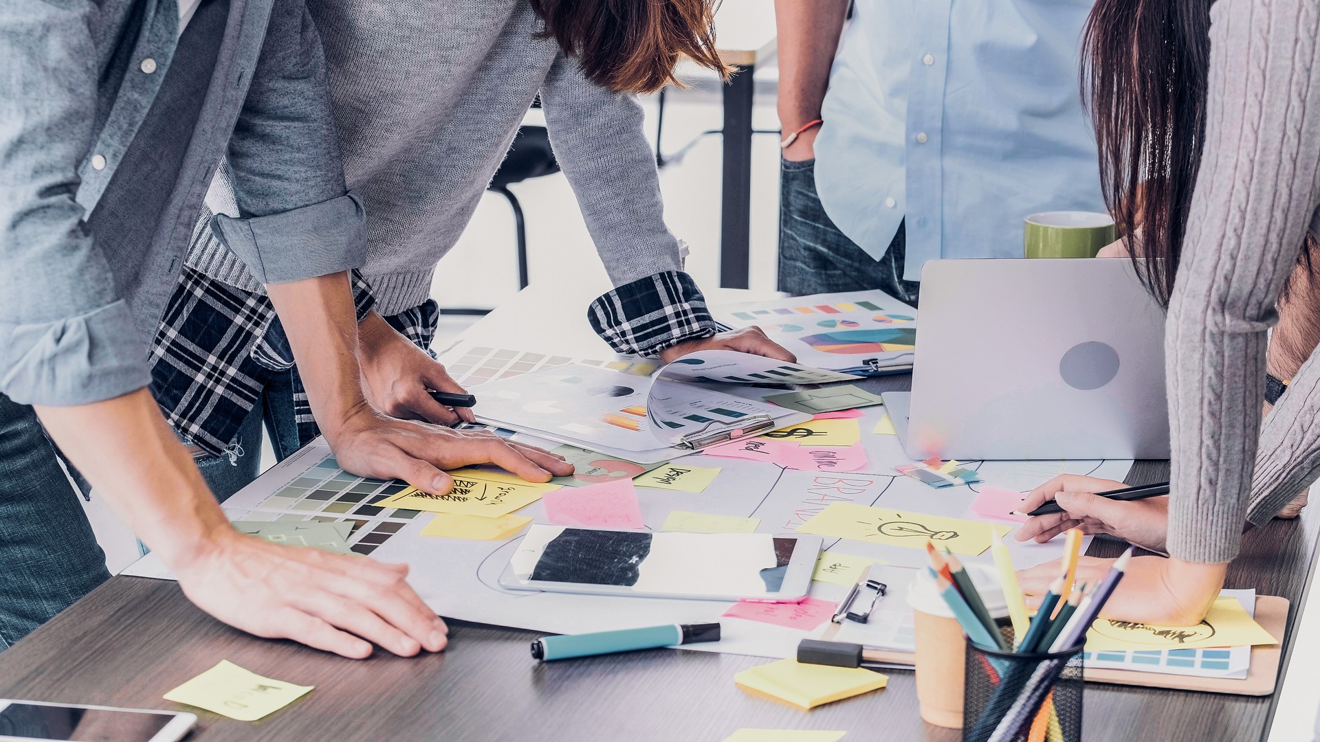 Close up creative designer applaud for job success at meeting table at office.